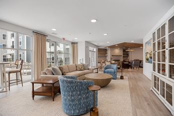 a living room with couches and chairs and a tableat Oak Grove at Blake Farm, Wilmington
